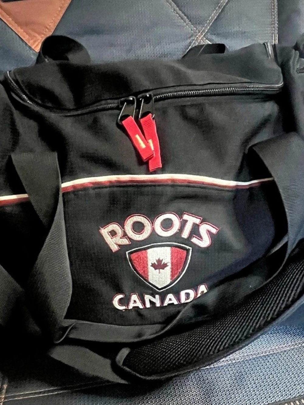 Roots Travel Duffel Bag in Black & Red